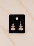 Golden Blush Heart Earrings featuring pink zirconia on a black card display.