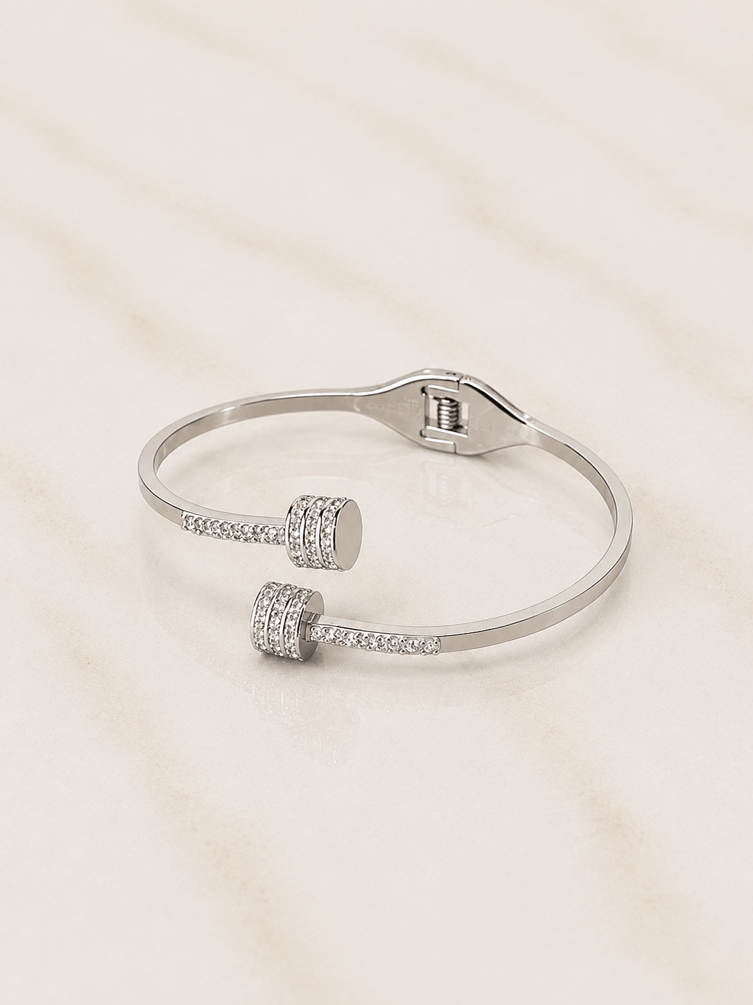 The Imperial Twist Bracelet showcasing a modern design with elegant twisted lines and sparkling accents.