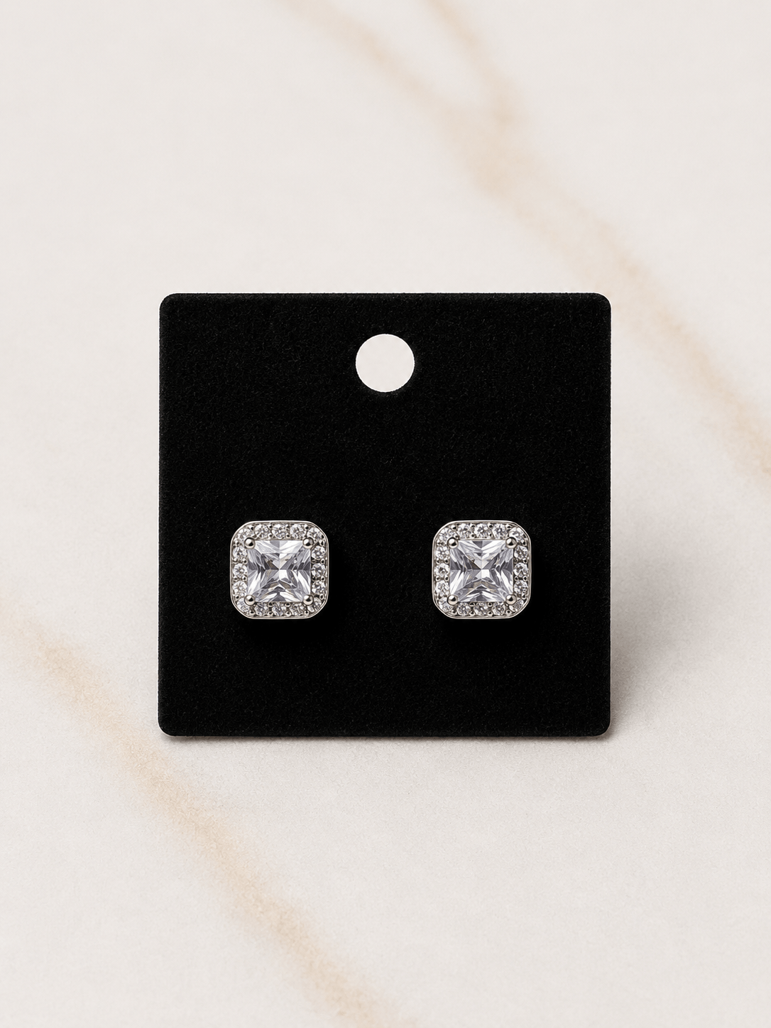 The Reign Diamond Studs elegant diamond-studded earrings on display against a black background.