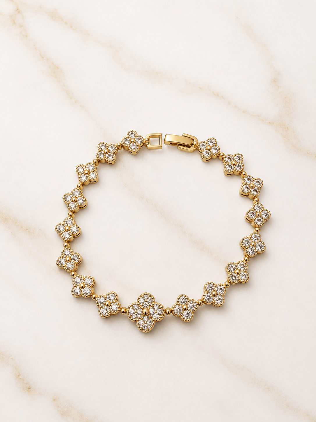 The Blossom Tennis Bracelet featuring cubic zirconia clusters and a gold finish, perfect for adding elegance to any outfit.