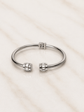 The Royal Radiance Cuff featuring a sleek design with baguette-cut crystal barrel accents on a marble surface.