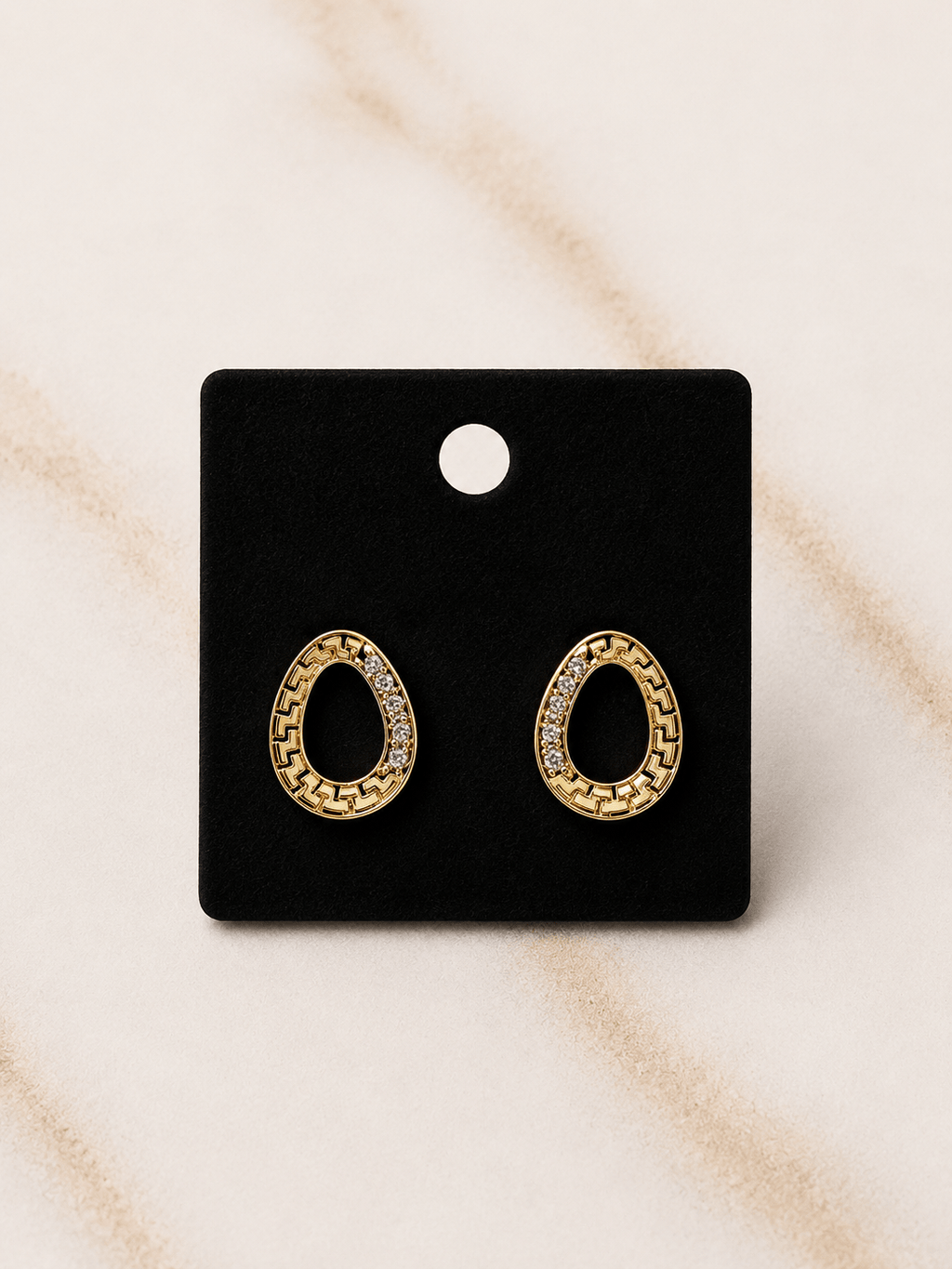The Eternal Circle Earrings featuring gold circle silhouette with diamond-inspired stones.