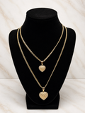 The Royal Heart Bond Necklace displayed on a black bust, featuring two gold chains with heart pendants.